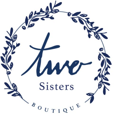 A logo with the words "Two Sisters Boutique" in the center, surrounded by a circular, leafy wreath design, reminiscent of the elegance often associated with Two Rivers Accounting. - Rice Lake Chamber of Commerce